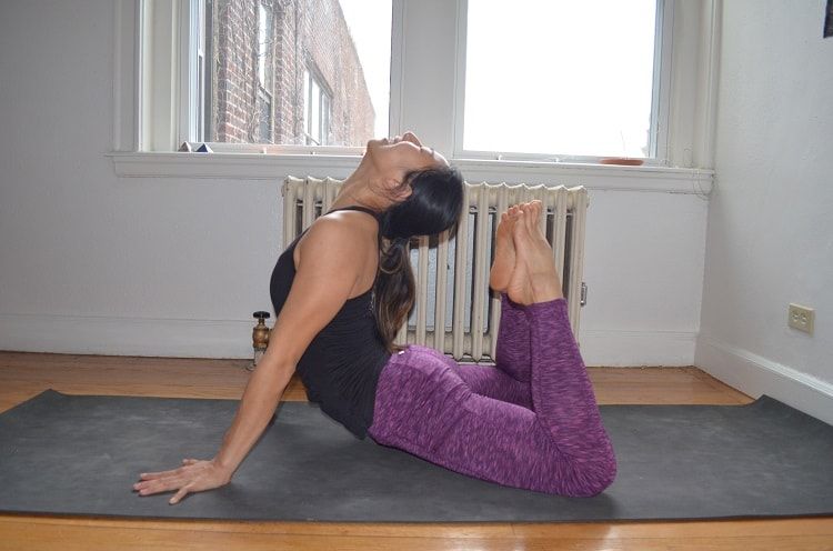 Man Practicing Raja Bhujangasana Or King Cobra Yoga Pose by